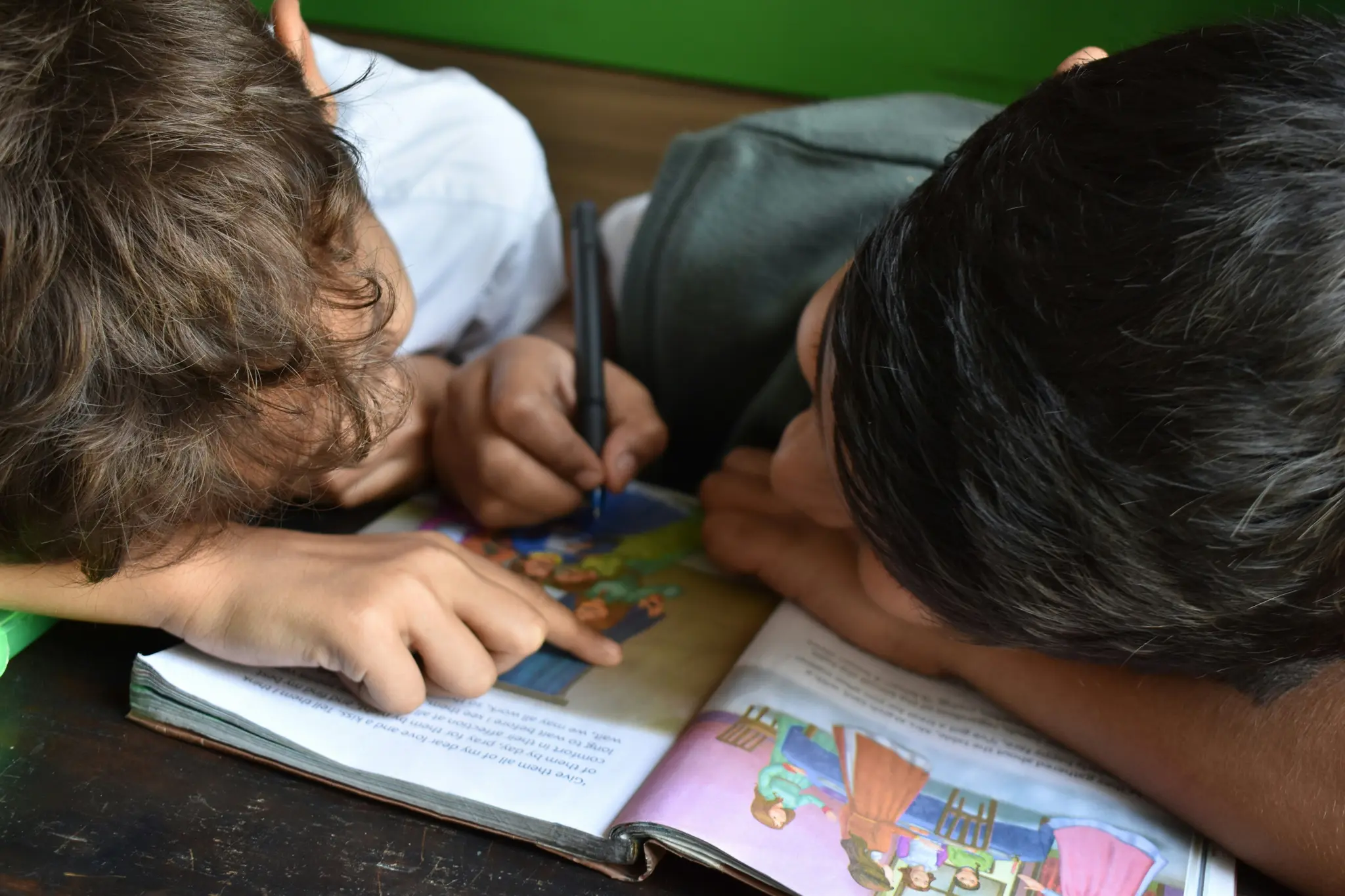 Two children reading a book